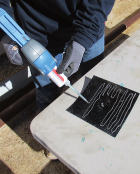 Technician applying Flat Patch Tank Repair Kit